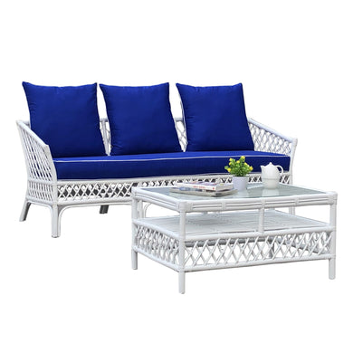 White wicker outdoor furniture set with blue cushions on a white background